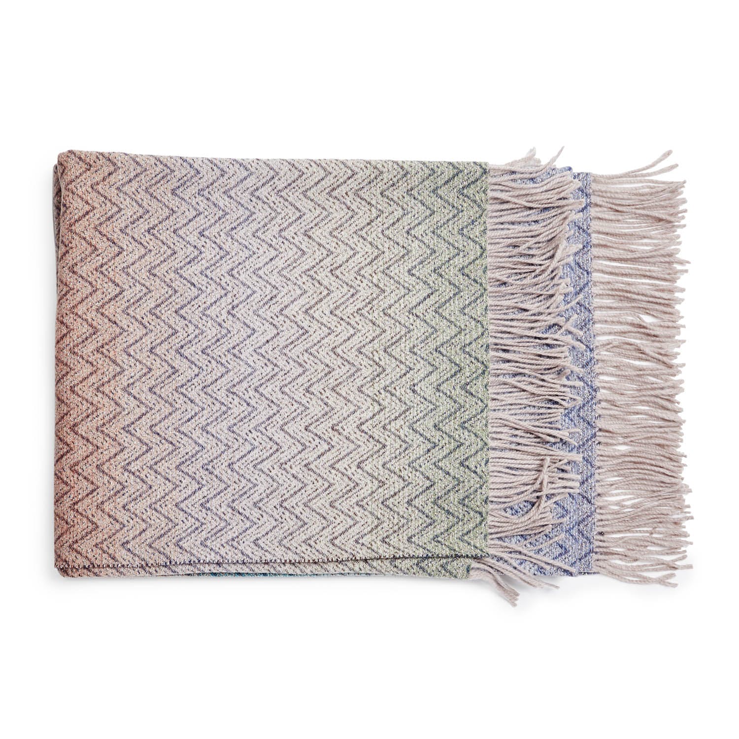 Neatly folded herringbone throw blanket with gradient colors and fringe.