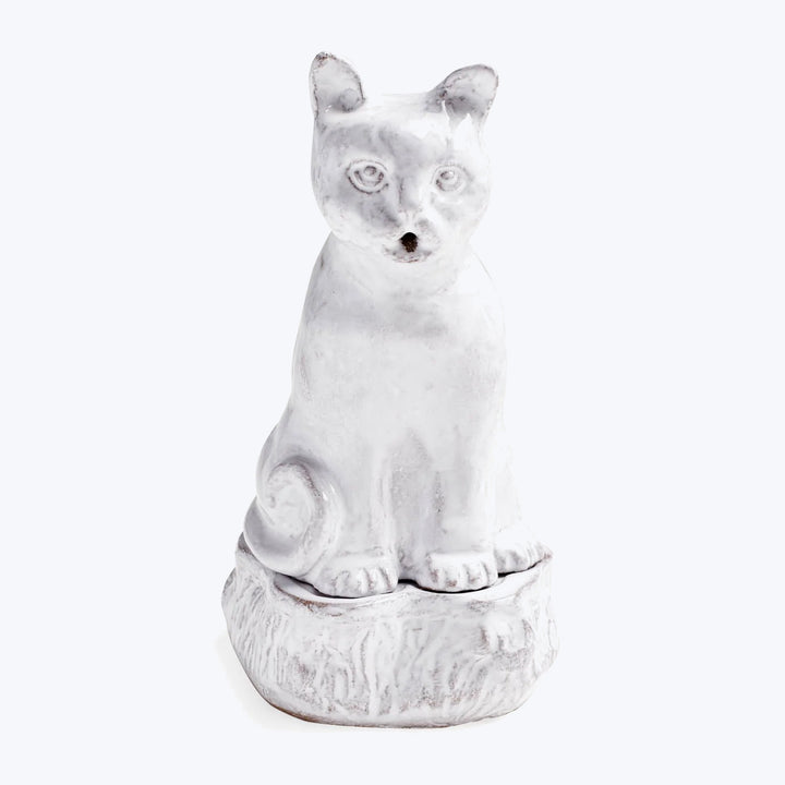 White ceramic cat figurine with open mouth and wide eyes.