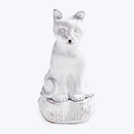 White ceramic cat figurine with open mouth and wide eyes.