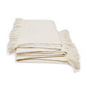 Cozy cream throw blanket with fringed edges offers warmth and style.
