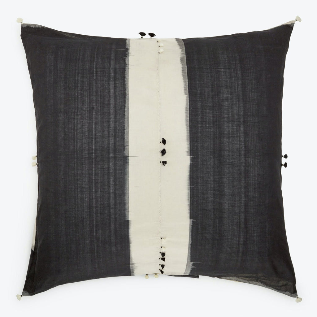 Contemporary square pillow with two-tone design and decorative closures.