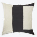 Contemporary square pillow with color-block pattern and decorative accents.