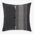 Decorative throw pillow with two-tone design and intricate patterns.