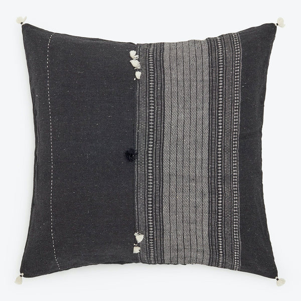 Decorative throw pillow with two-tone design and intricate patterns.