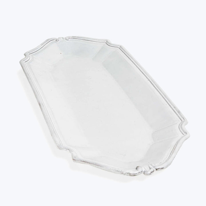 Clear glass hexagonal dish with ornamental edges and raised sides.