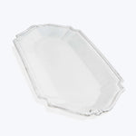 Clear glass hexagonal dish with ornamental edges and raised sides.