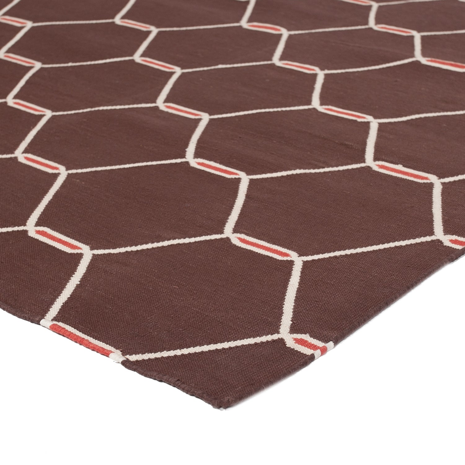 Close-up of brown fabric with white hexagon pattern and texture.