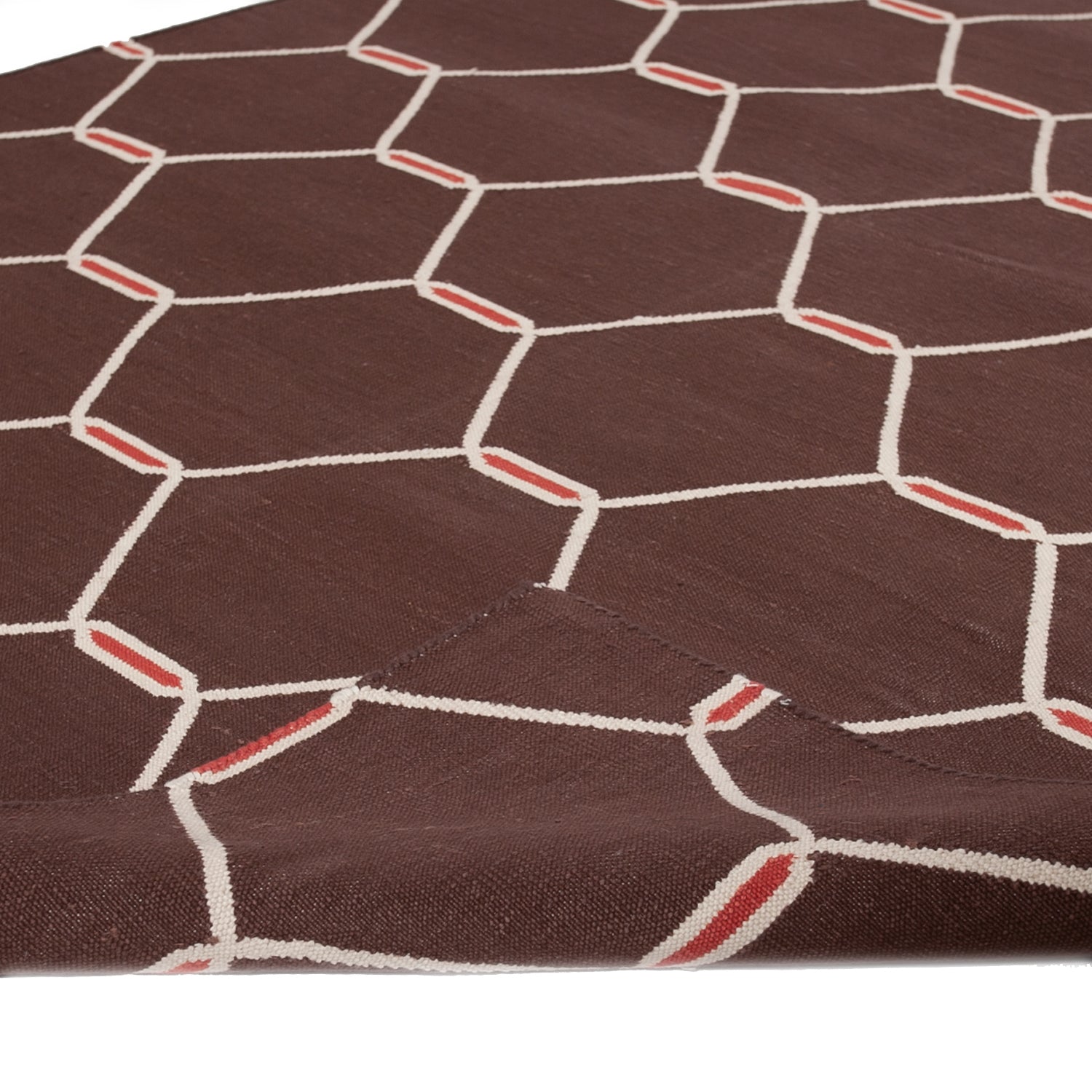 Close-up of textured fabric with regular geometric pattern in brown.