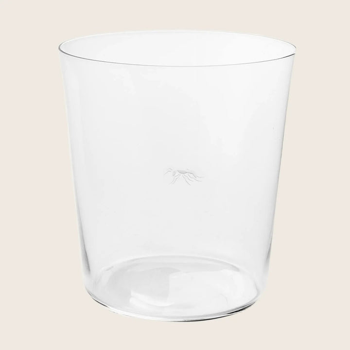 Clear glass tumbler on a white background, featuring subtle logo.