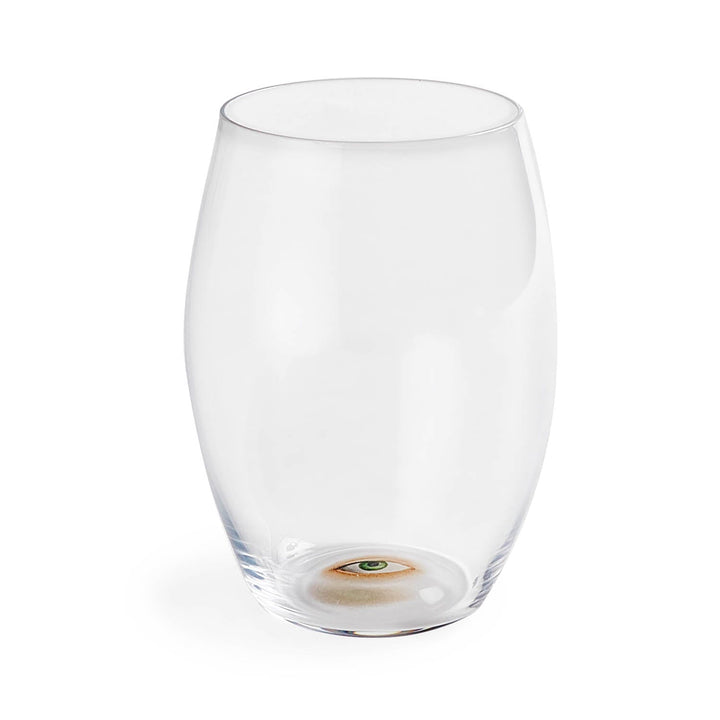 An empty glass with a lifelike human eye at the bottom.