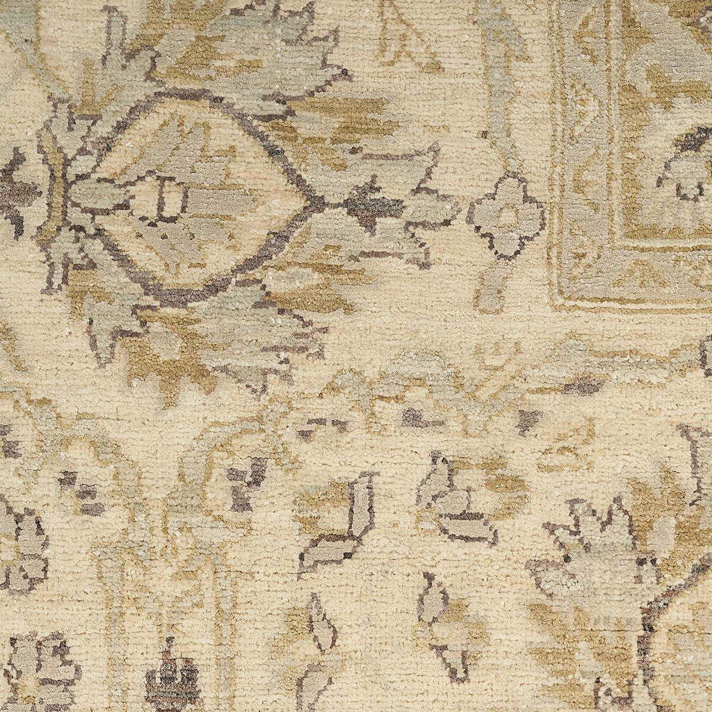Close-up of a traditional rug with intricate floral pattern.
