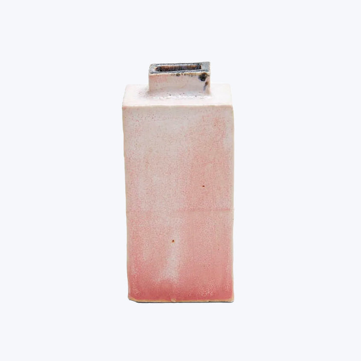 Vintage ceramic vase with a mottled pinkish glaze and wear