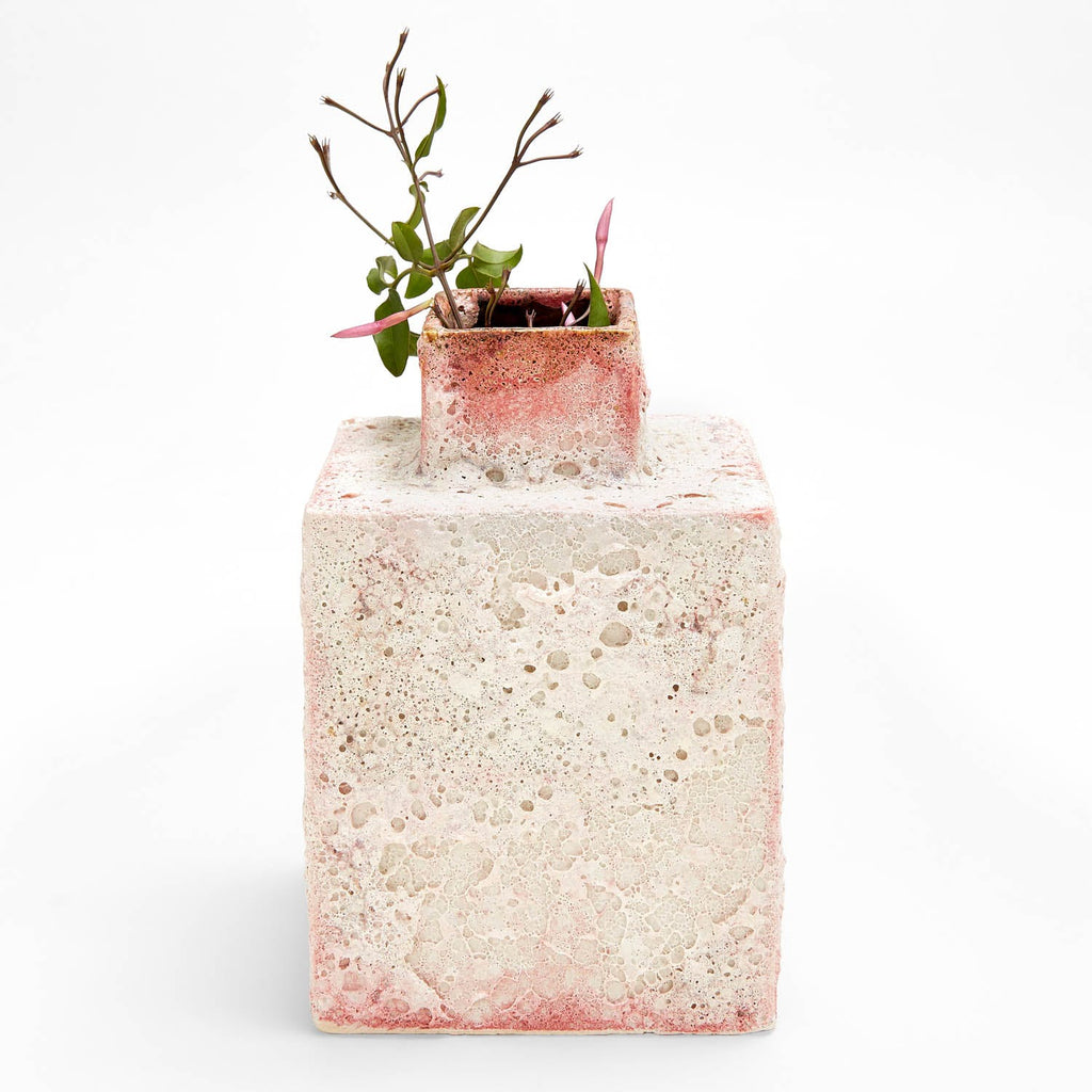Unique square-shaped pottery with organic texture and pinkish hue.