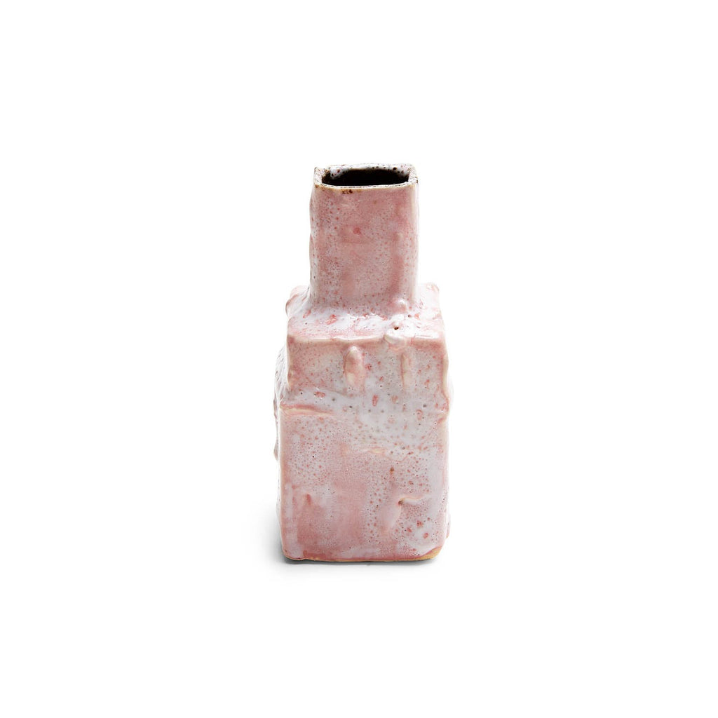 Abstract ceramic bottle with speckled glaze against white background