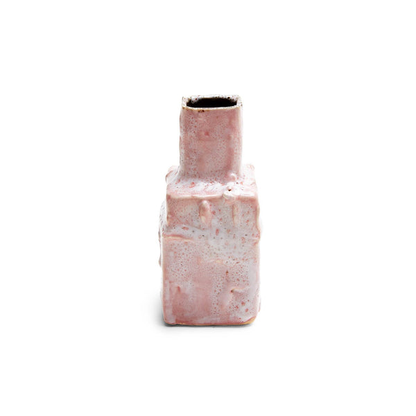 Abstract ceramic bottle with speckled glaze against white background