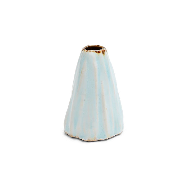 An aged pastel blue conical ceramic object stands on white.