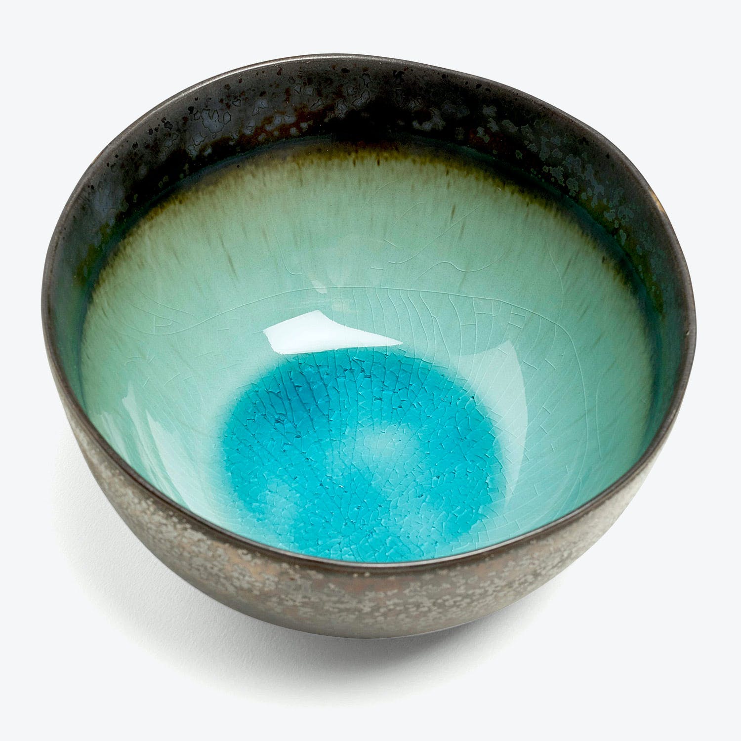 Ceramic bowl with textured glaze transitions from dark to vibrant