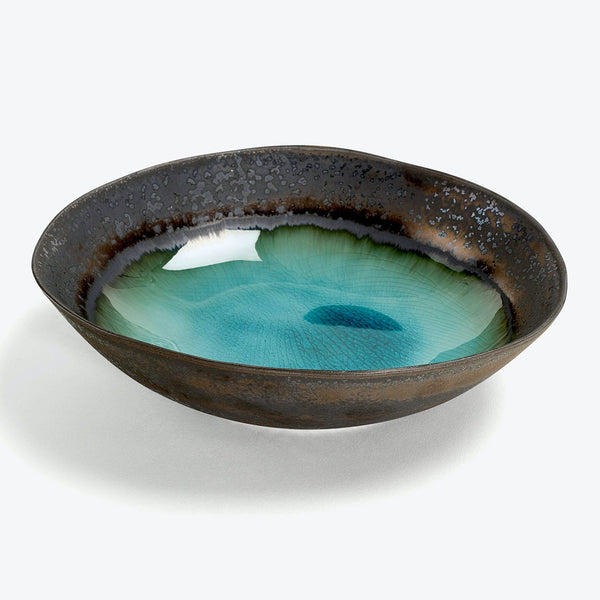 Ceramic bowl with striking glaze finish showcases illusion of depth