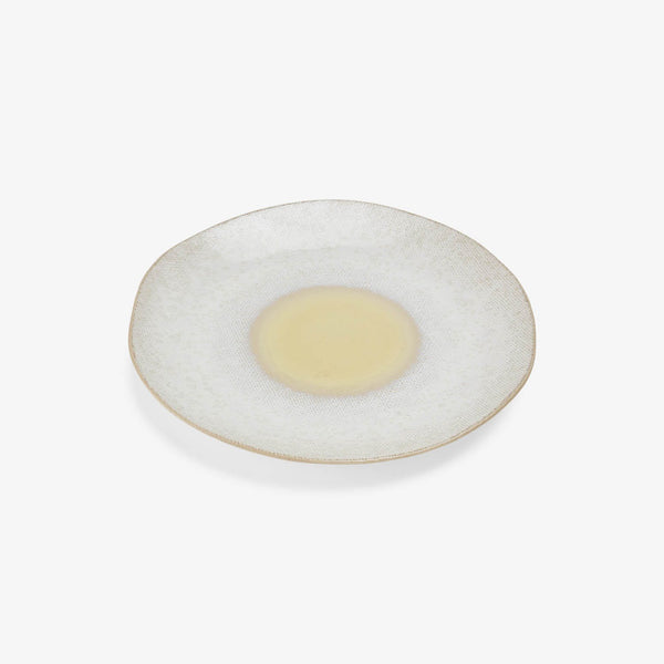 Handcrafted circular plate with textured glaze and distinct food placement area.