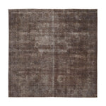 Faded vintage rectangular rug with distressed design in earthy tones.
