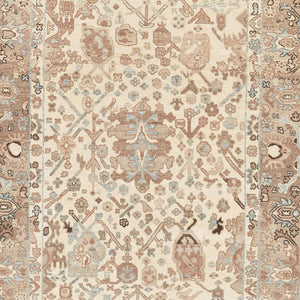 An ornate rectangular area rug featuring a symmetrical, muted design. - hover