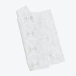 Folded paper towel with colorful spots resembling watercolor stains.