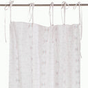 Colorful speckled shower curtain adds a decorative touch to bathroom.