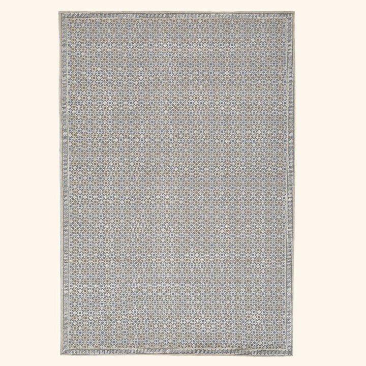 Symmetrical geometric rug with neutral colors and Greek key border.