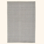 Symmetrical geometric rug with neutral colors and Greek key border.