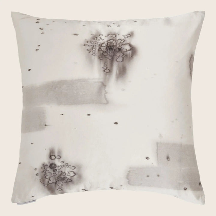 Stained pillow exhibits various patterns and sizes of dark marks.