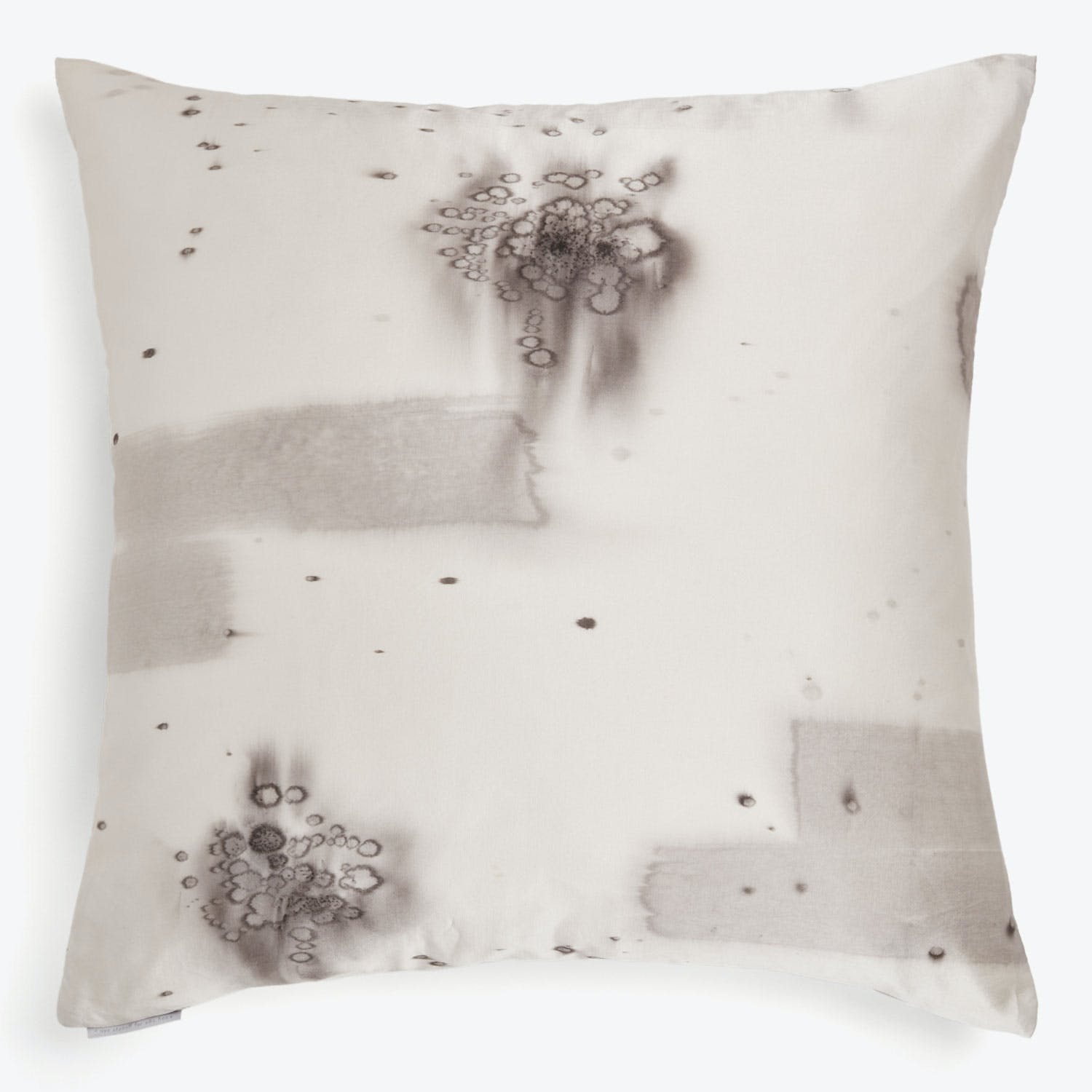 Stained pillow exhibits various patterns and sizes of dark marks.