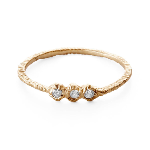 Delicate yellow gold ring with textured band and sparkling diamonds.