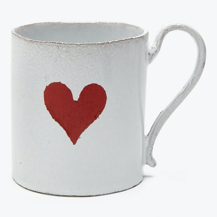Rustic white mug with distressed texture and painted red heart.