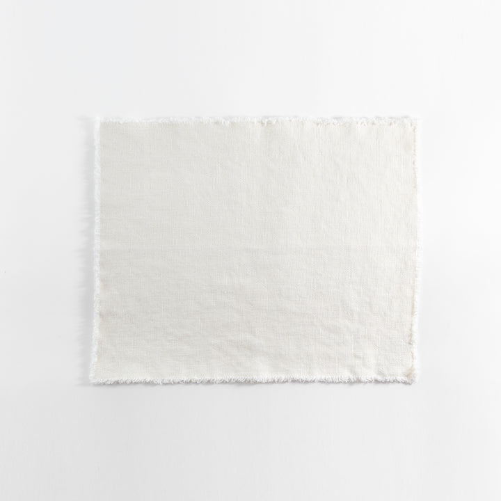 Plain undyed fabric with frayed edges on a white background.