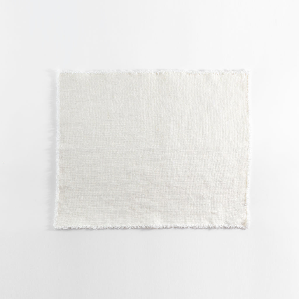 Plain undyed fabric with frayed edges on a white background.