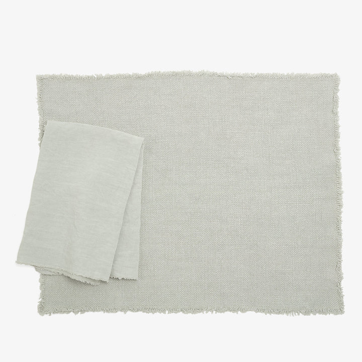 Two fabrics - textured and smooth - on a plain background.