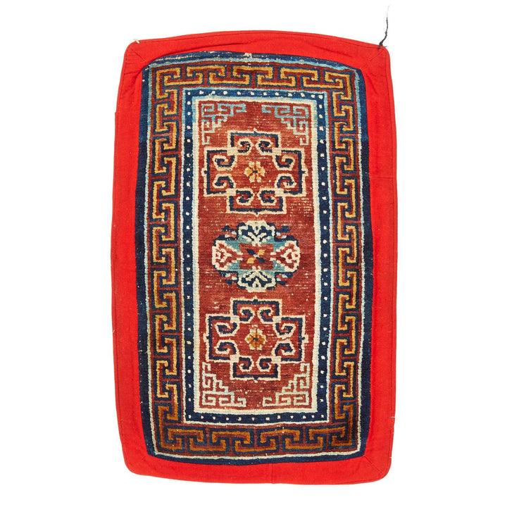 Intricately designed handwoven Oriental rug with hints of wear and vibrant colors.
