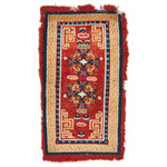 Hand-woven oriental-style rug featuring intricate symmetrical pattern design