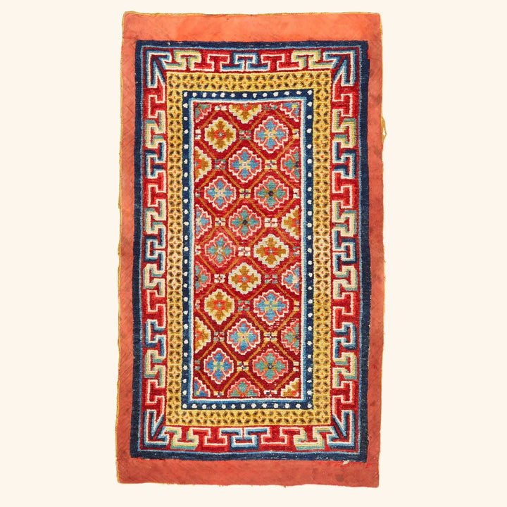 Vibrant and intricate handwoven rug with symmetrical geometric and floral motifs