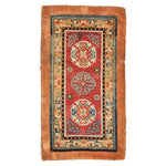Antique oriental rug with intricate designs in vibrant red and blue.