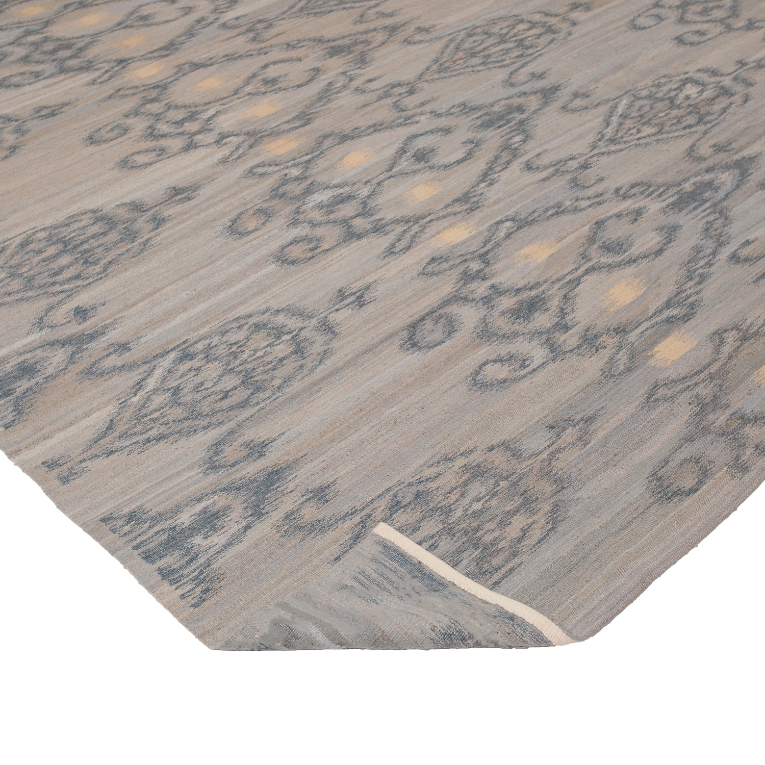 Elegant vintage-style carpet with intricate grey and gold pattern.