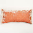 Rectangular crushed velvet throw pillow in peach with fringed edges.
