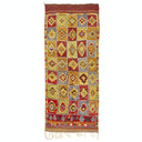 Colorful geometric rug with intricate woven patterns and fringe detail.