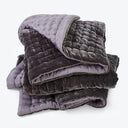 Luxurious and cozy weighted blanket in shades of gray and purple, perfect for relaxation and comfort.