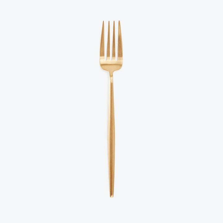 Gold fork with four tines and sleek handle on white background.