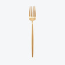 Gold fork with four tines and sleek handle on white background.