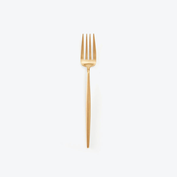 Minimalist gold-toned fork with classic design against plain background.