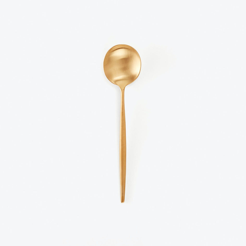 Gold spoon showcases elegant design and minimalist presentation on white.