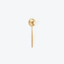 Elegant gold spoon with a matte finish on white background.