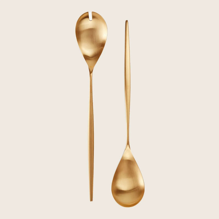 Two modern, golden utensils - slotted and serving spoons.
